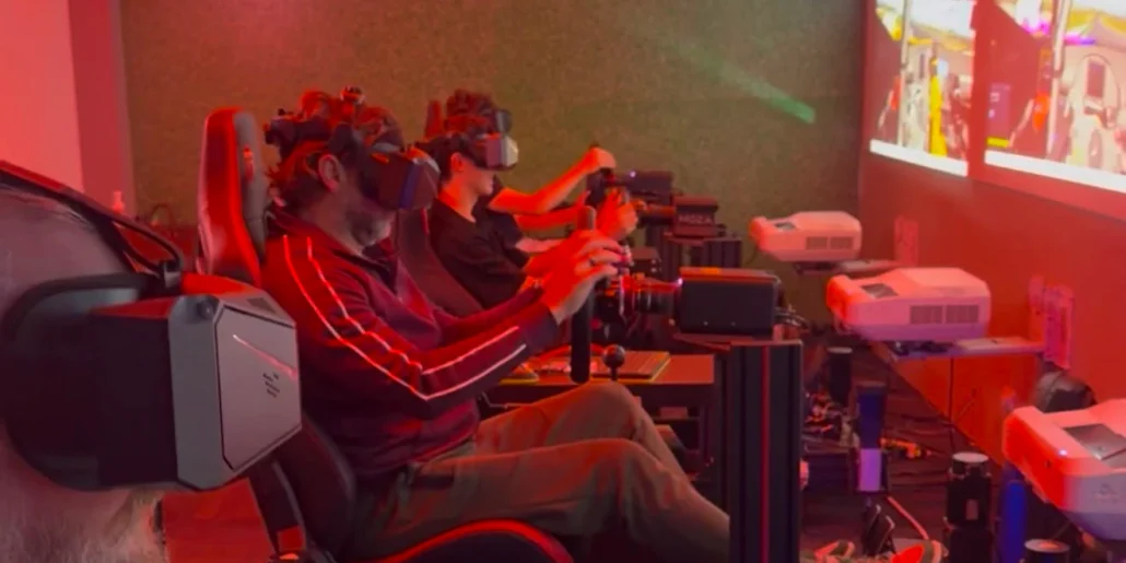 A row of drivers racing in VR headsets at Sim Racing Adelaide